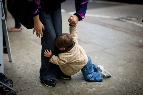 A parent handling her kid during a meltdown