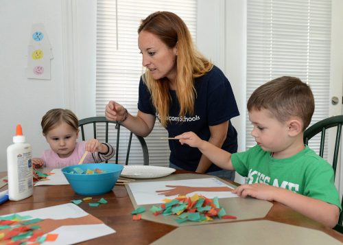 a parent teaching art to her kids